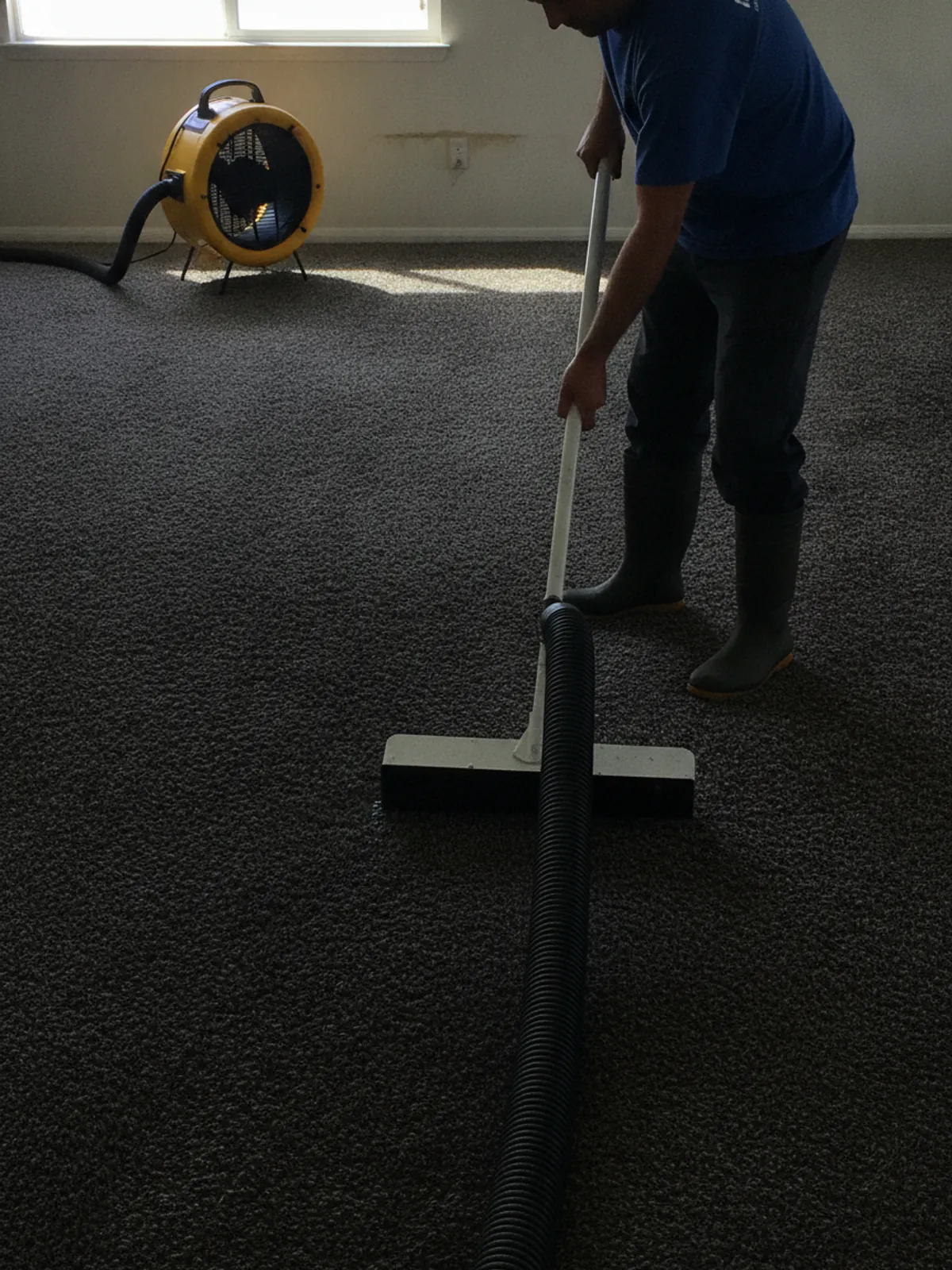 Water damage restoration technician extracting standing water from a Los Angeles home